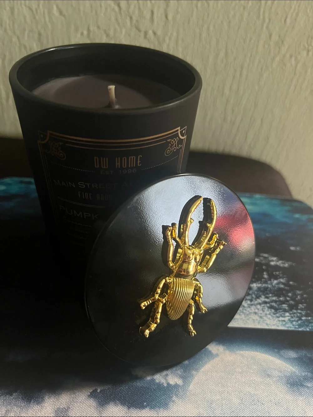 #3,007**DW Home Pumpkin Bourbon Candle Jar in Black and Gold